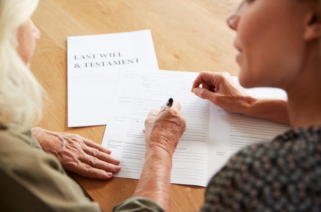 Two women working on paperwork on a desk